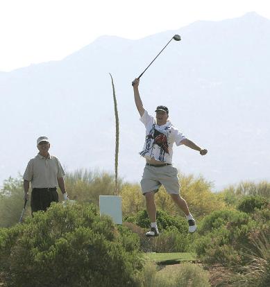 Jim Purdy celebrates a big hit and Chuck Sjoberg marvels at th Golf Club at Vistoso in Tucson, Ariz. Photo by David Sanders.